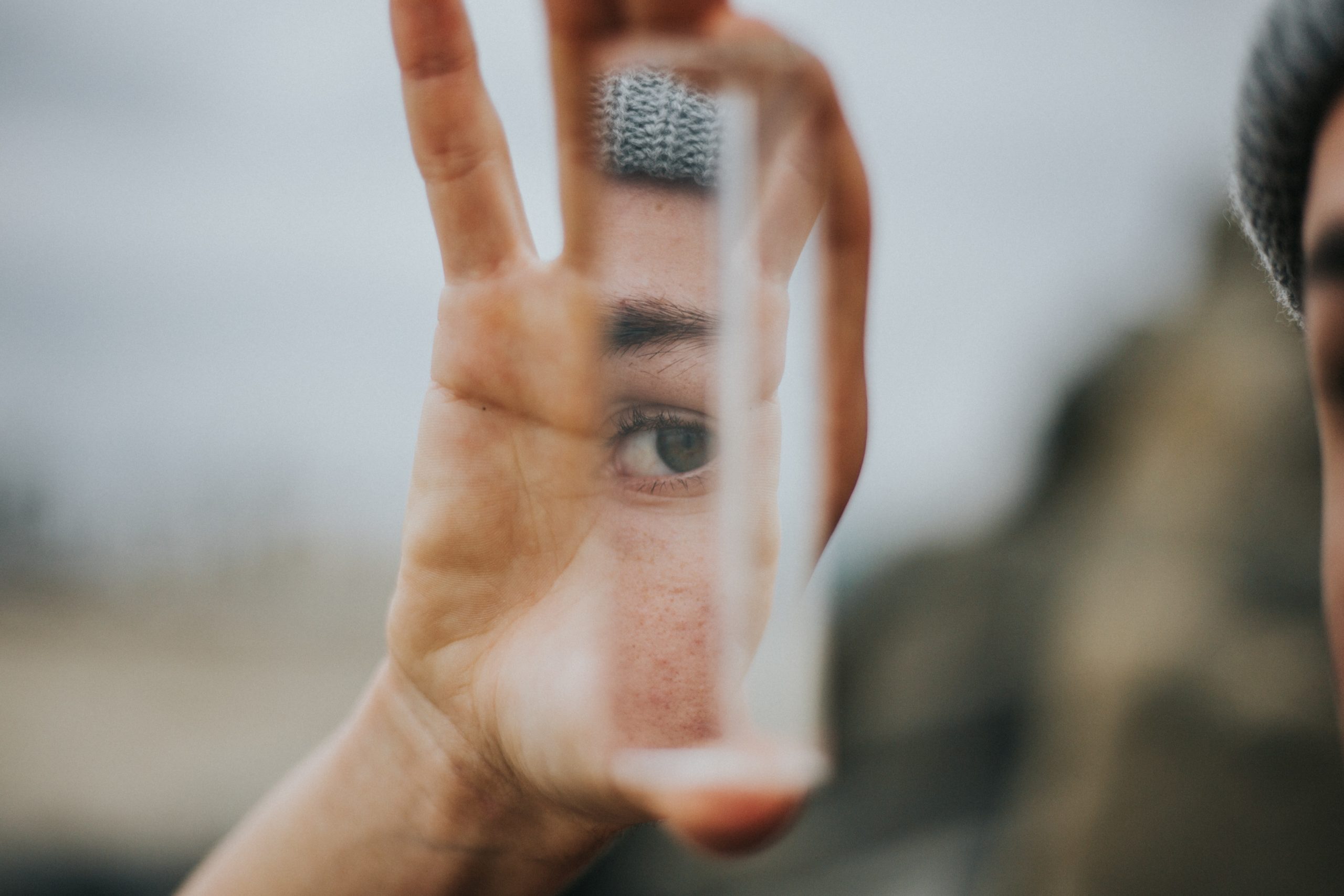 shallow focus person holding mirror